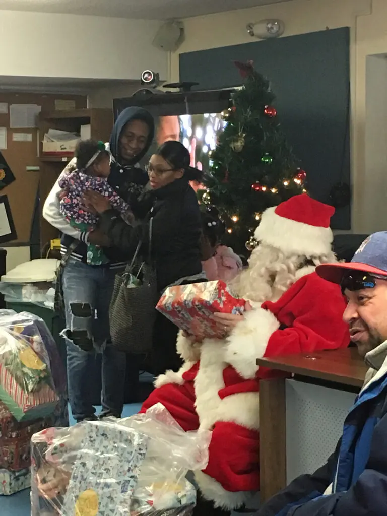Children and parents meeting Santa Claus at the MHPC holiday party