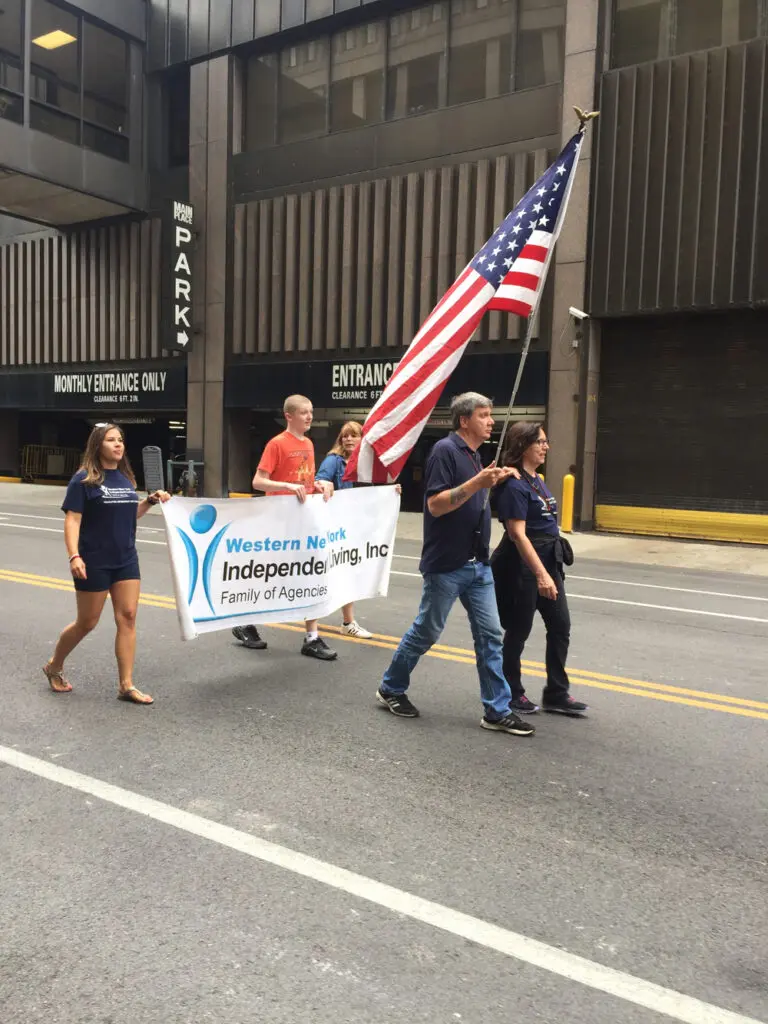 WNYIL parade walkers with flags