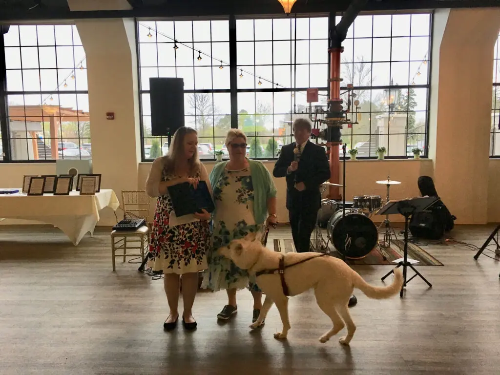 Award winner with service dog at gala