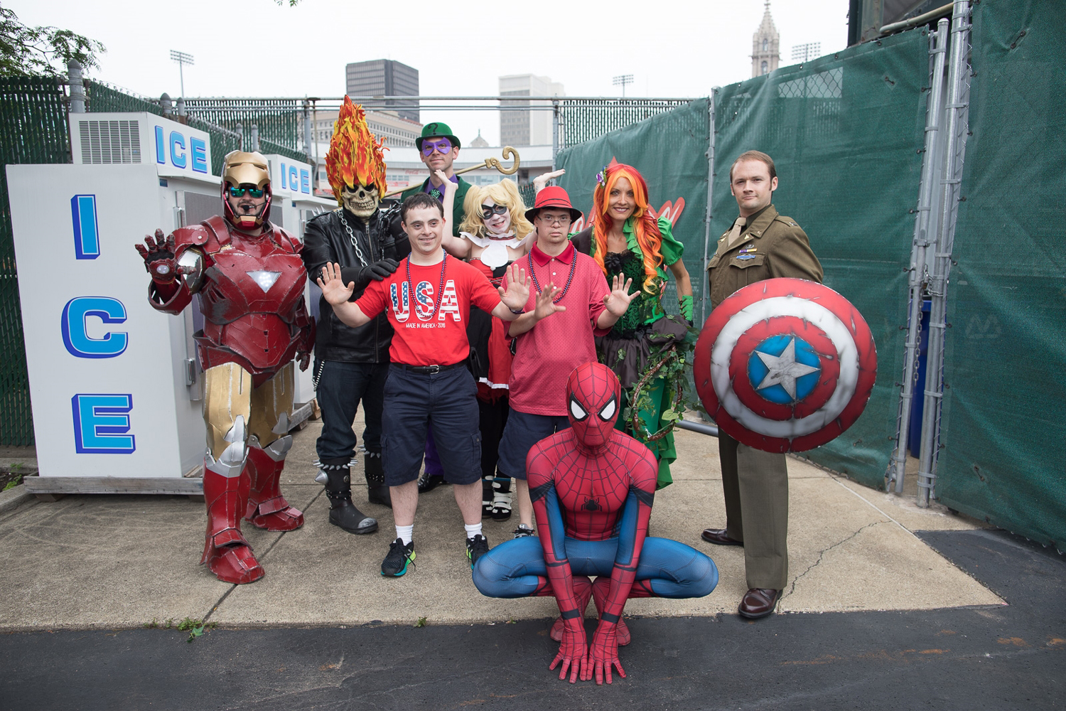 Superheroes pose with group at disability parade